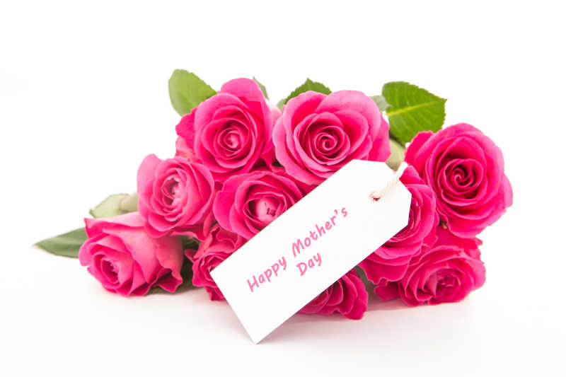 在白色背景下一束粉红色的玫瑰和一张快乐的母亲贺卡