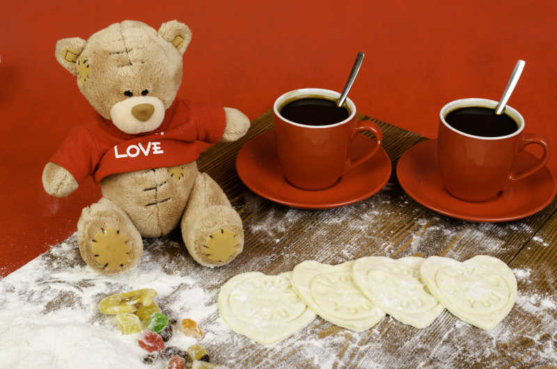 泰迪熊两杯咖啡还有心形的面饼