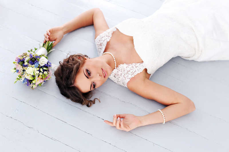 躺在木板上的新娘和捧花