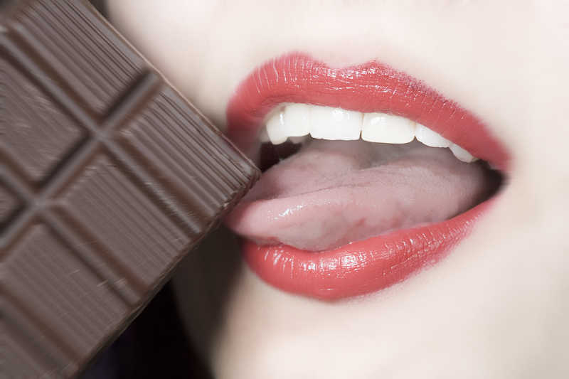 女人伸舌头吃巧克力