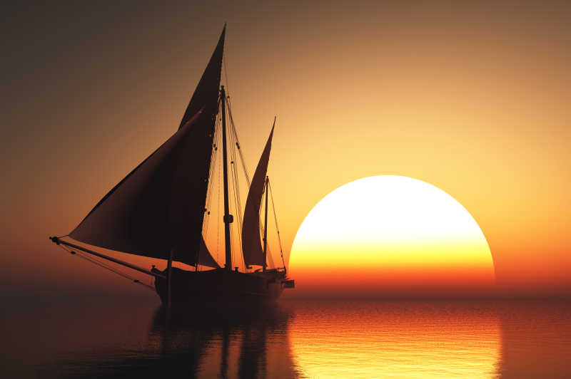 日落时分在海上逆流而上的帆船