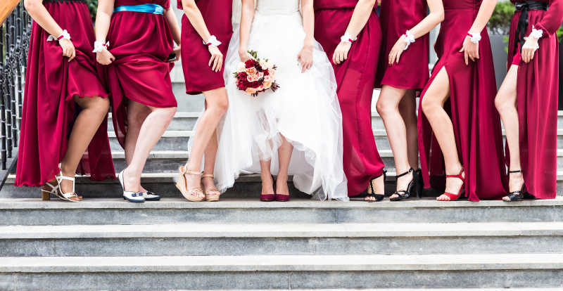 白色婚纱新娘和红礼服伴娘团