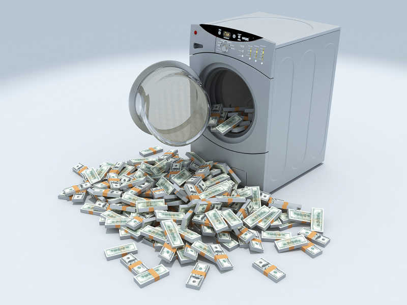 白色背景下滚筒洗衣机里的美元现金