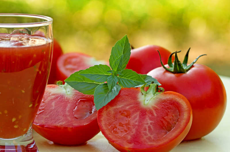 杯中的番茄汁与桌子上的番茄