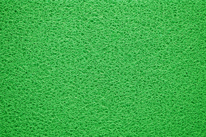 绿色纹理背景的地毯或门垫特写