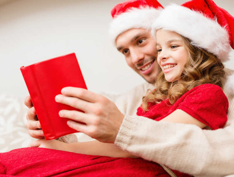 圣诞节开心的父亲和女儿读书