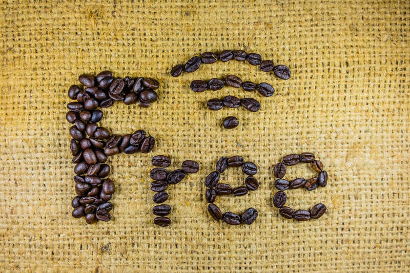 黄色亚麻布上咖啡豆组成的免费WiFi字样