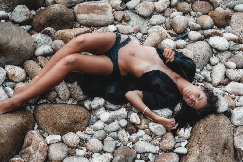 沙滩石头上的性感女模特