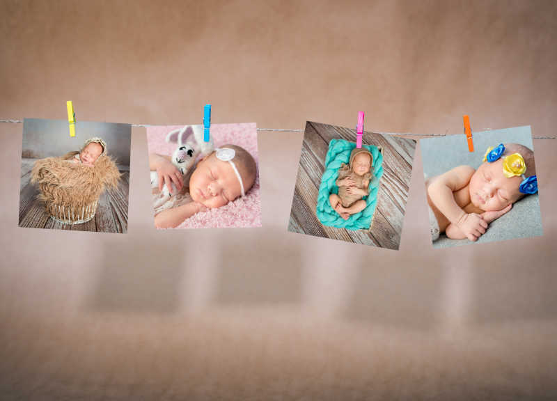 牛皮纸背景挂在绳子上的婴儿睡觉的照片