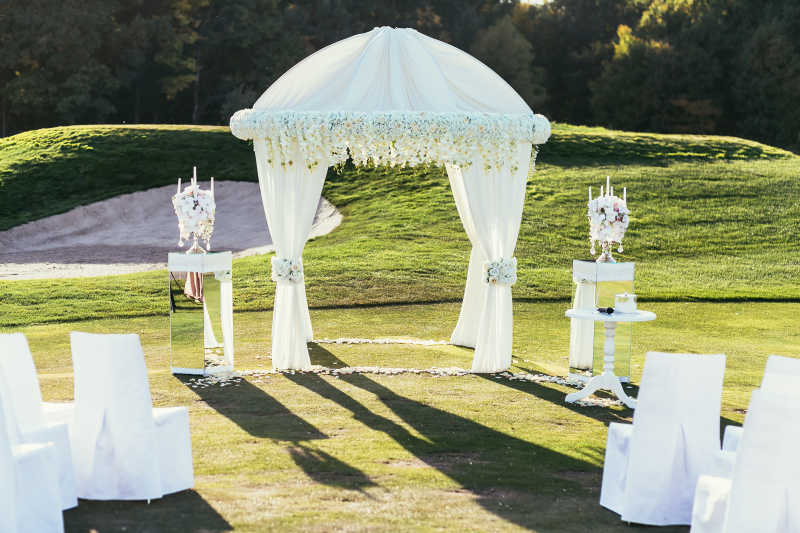 鲜花和白色幔布装饰的婚礼现场