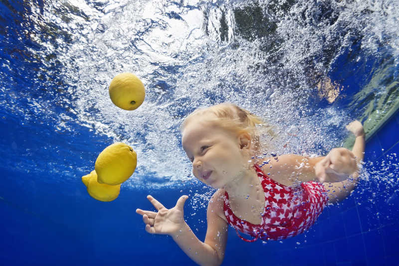 下水潜泳去拿柠檬的小女孩