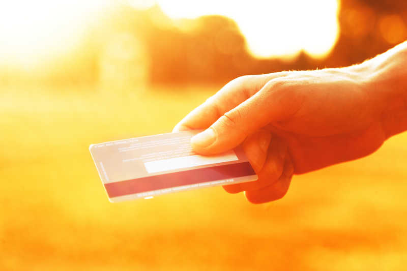 阳光下的手里的信用卡