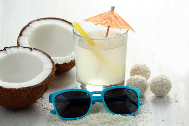 木板上的椰子椰果和太阳眼镜