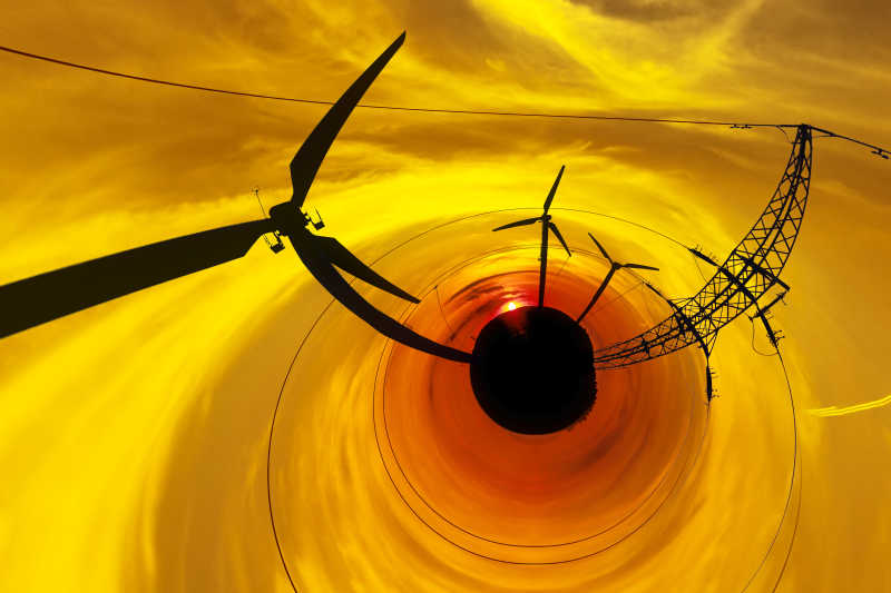 夕阳下的风力发电机抽象视图