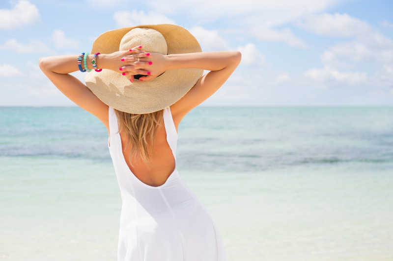 海滩上戴着太阳帽的休闲美女