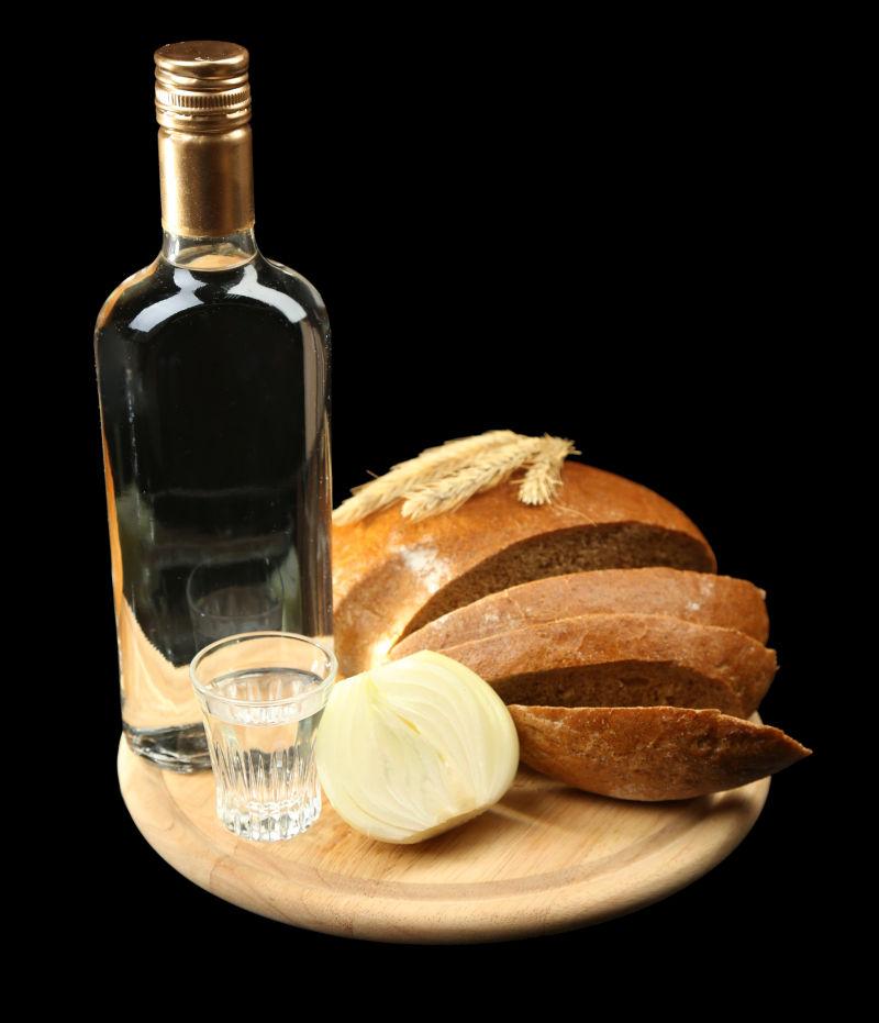 一瓶酒与新鲜面包和玻璃杯在木板上
