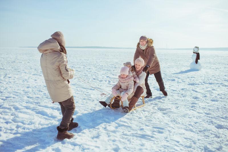 在玩雪橇的一家人