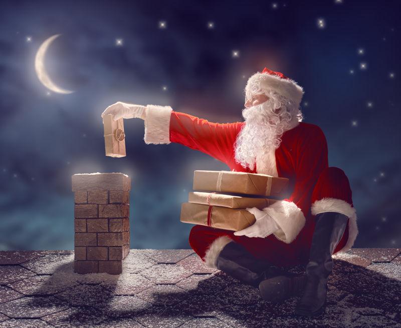圣诞老人坐在屋顶上派送礼物