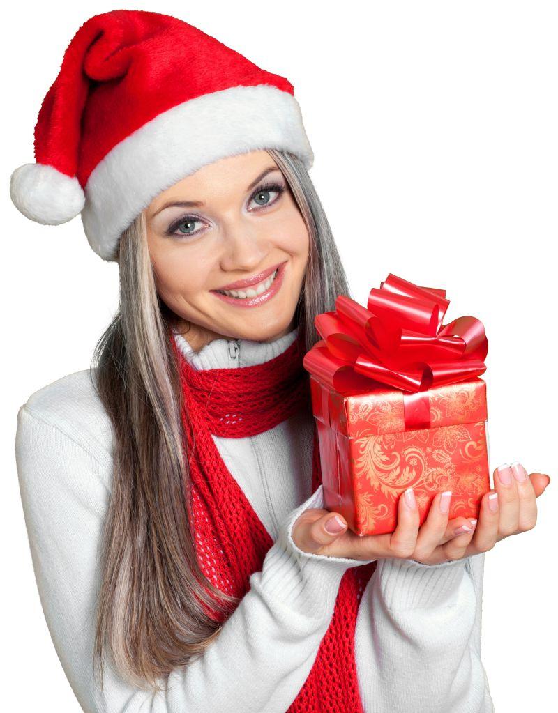 戴圣诞帽的美女捧着礼物在微笑