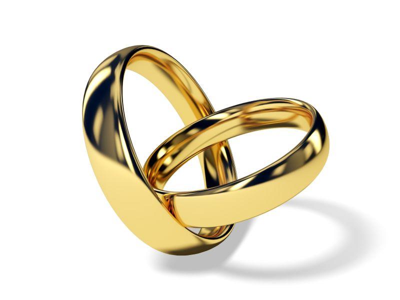 白色背景下一对金结婚戒指
