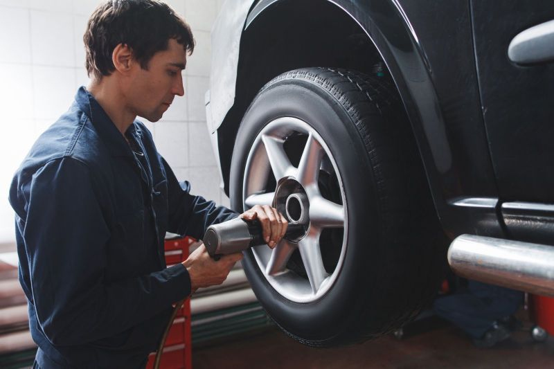 汽车维修人员在为汽车更换轮胎