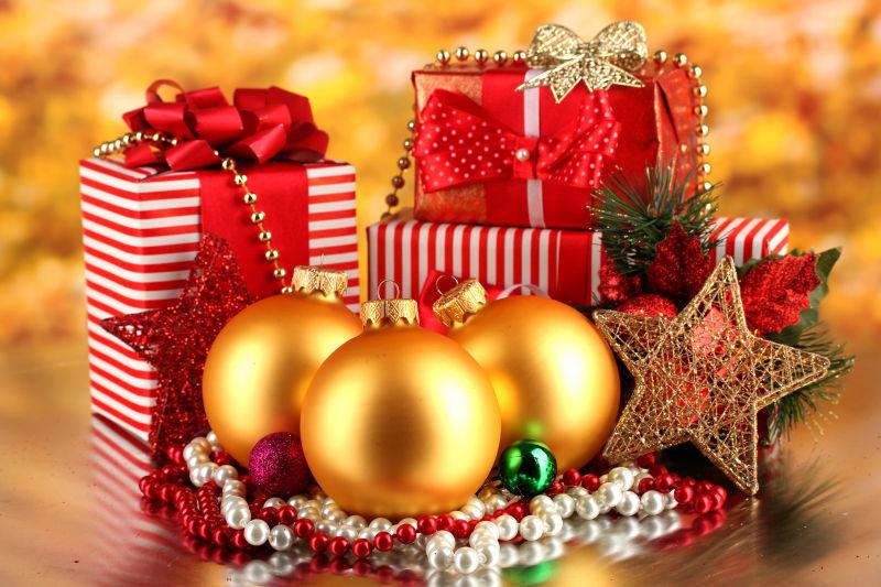 金色背景下的红色的圣诞节礼品盒和装饰品