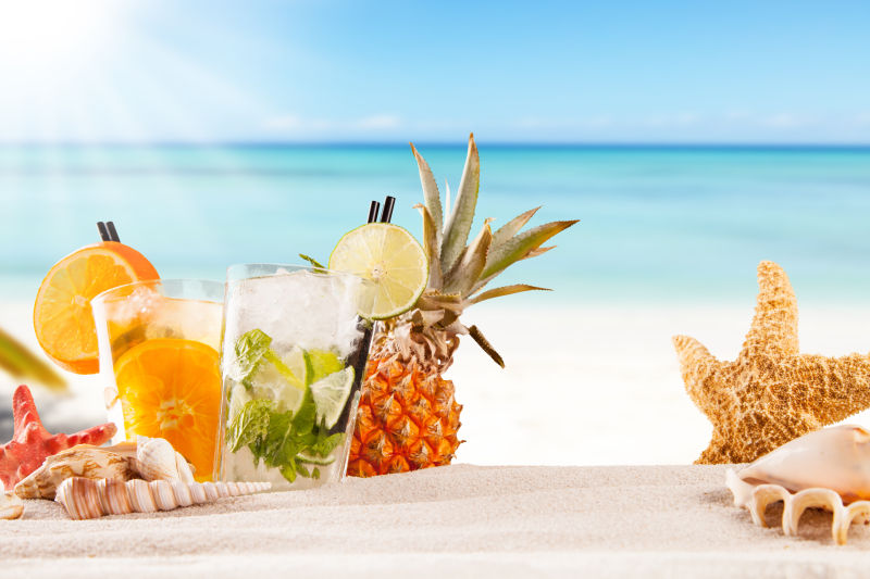 阳光沙滩背景下的水果饮料
