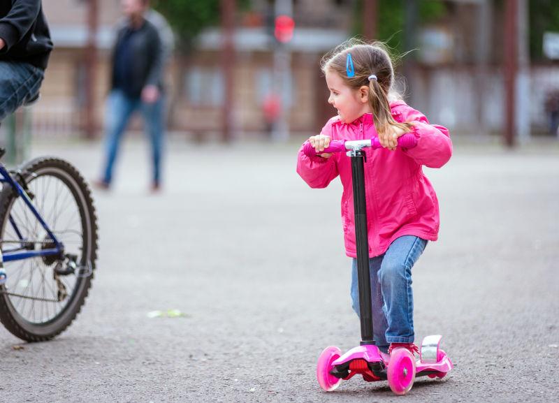 一个可爱的小女孩在城市里骑脚踏车