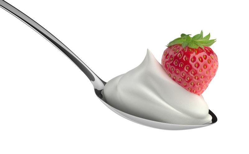 白色背景上勺子里的奶油和草莓