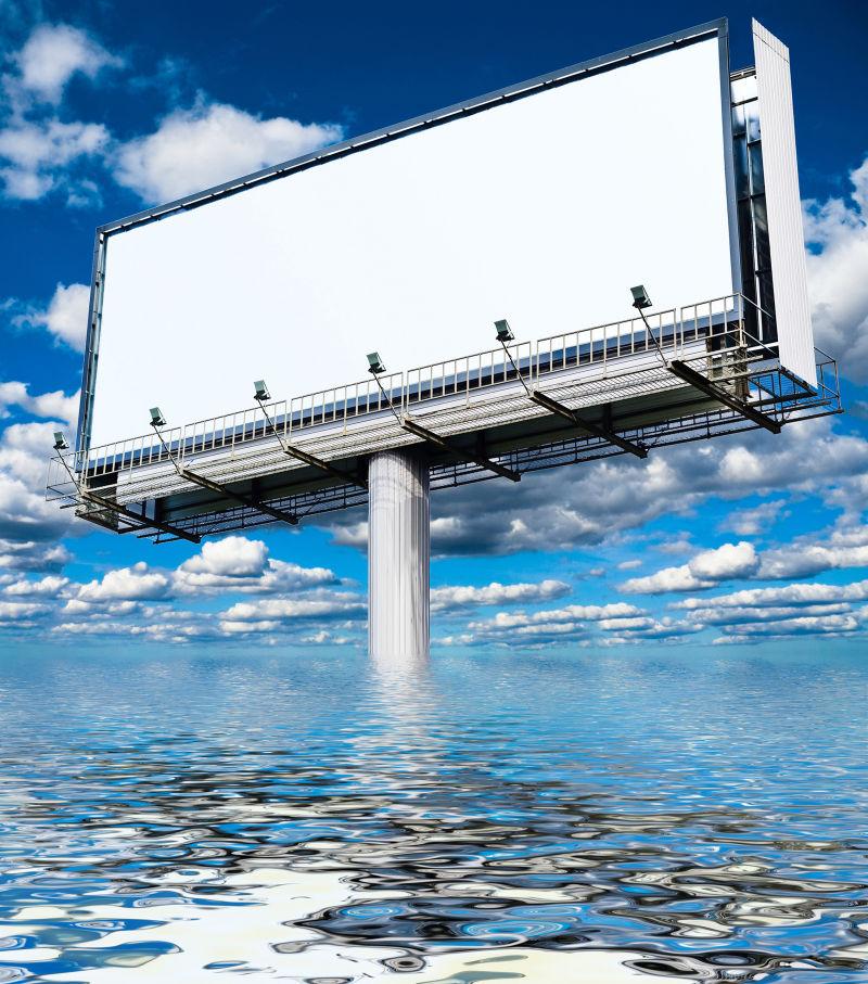 蓝天白云下耸立在海水中的大型空广告牌