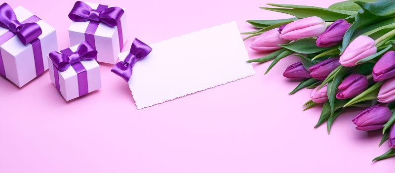 桌子上的郁金香花束和礼物贺卡