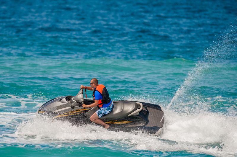 热带海洋里年轻人乘喷气式摩托艇