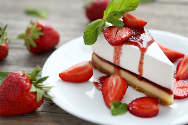 木桌上的草莓芝士蛋糕