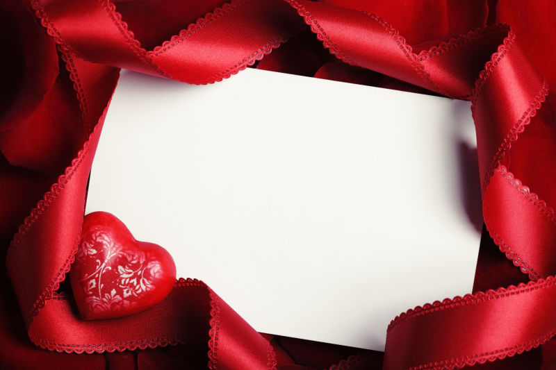 红色丝绸背景中的情人节卡片