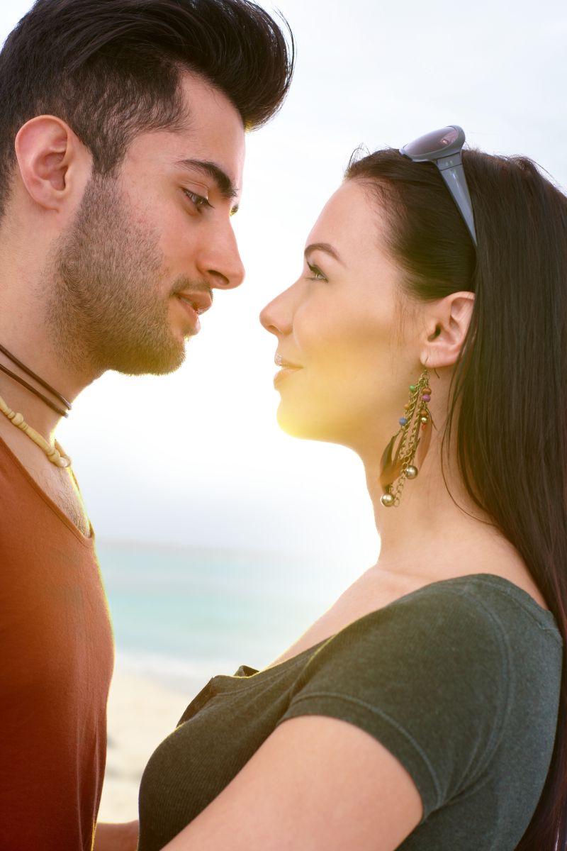 年轻恋人在海滩亲吻