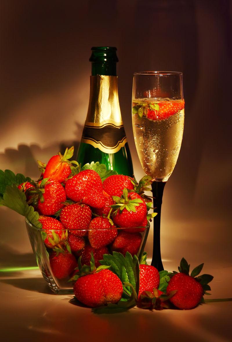 淡黄色背景下的香槟酒和草莓