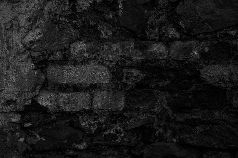 古老的黑色砖墙背景