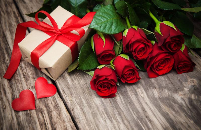 情人节红玫瑰和木桌上的礼品盒