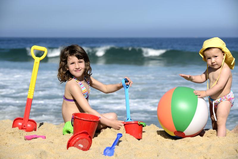 沙滩上两个玩沙的孩子
