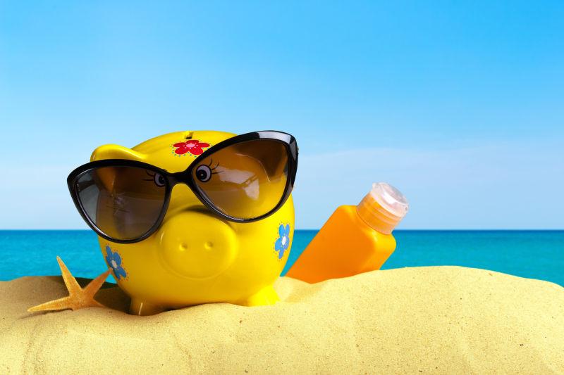 海滩上戴着太阳镜的存钱罐