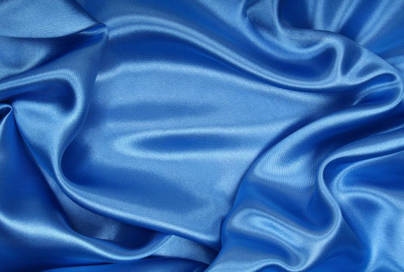 平滑飘逸的蓝色丝绸背景