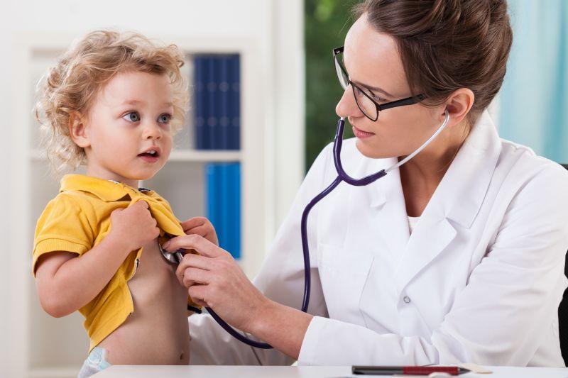 用听诊器给儿童检查身体的医生