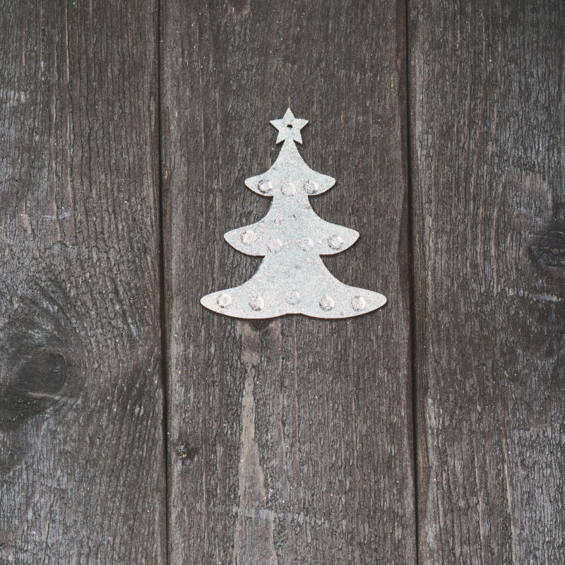 木制年份背景下的银圣诞装饰