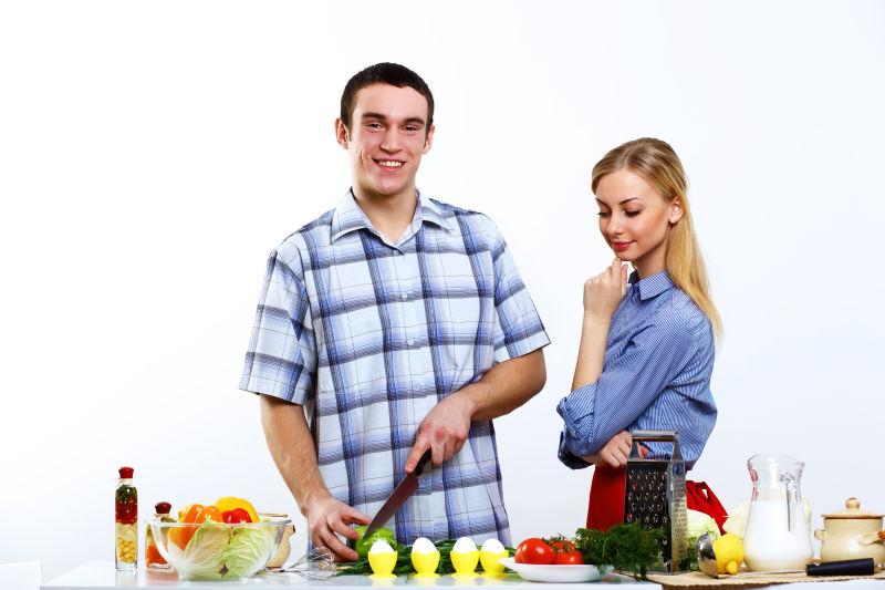 白色背景中一起做饭的年轻夫妇