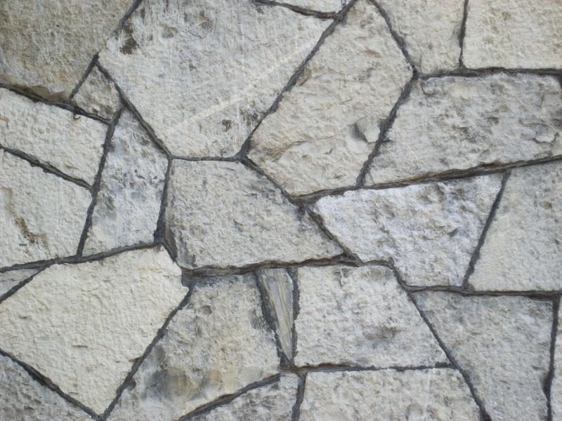 菱角分明的碎石头石墙背景