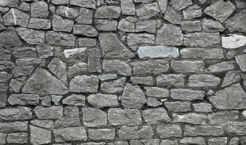 横竖不规律堆砌的石头墙背景