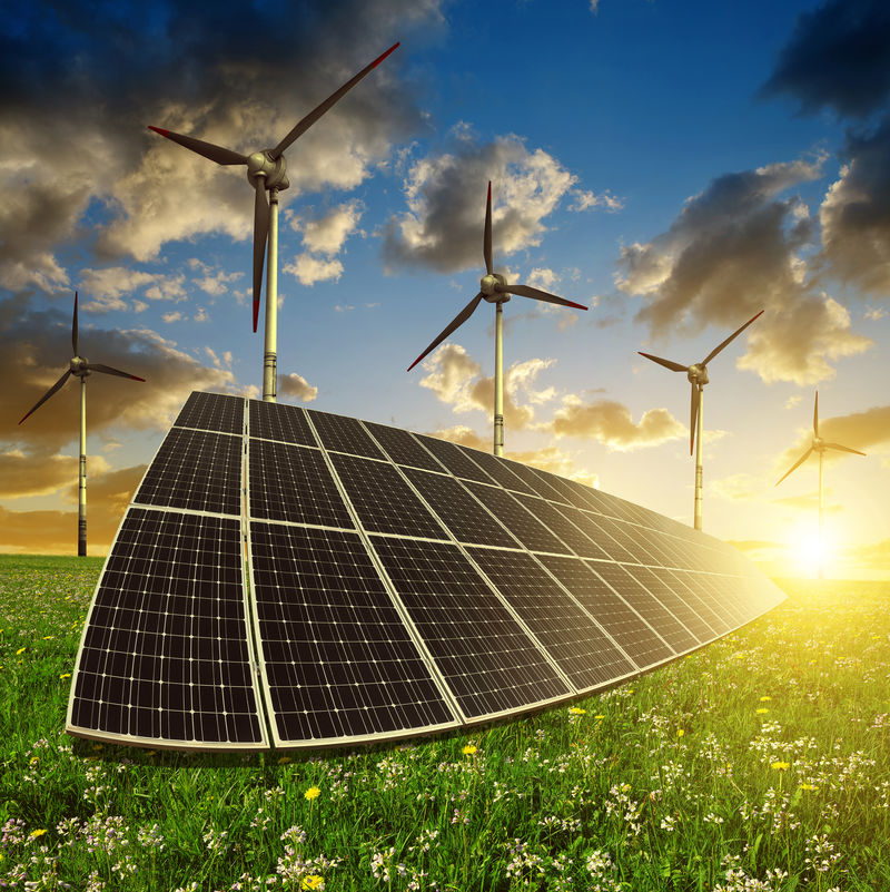 太阳落山时带风力涡轮机的太阳能电池板能源概念