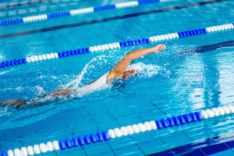 在游泳池里训练的女游泳运动员-前爬式游泳