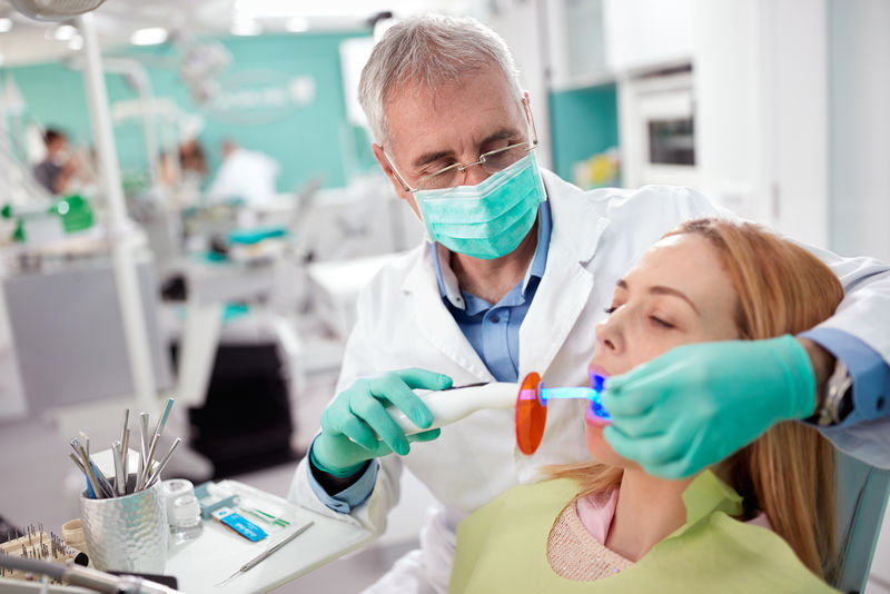 牙医在牙科实践中使用的仪器-具有光干燥和加强牙齿填充物