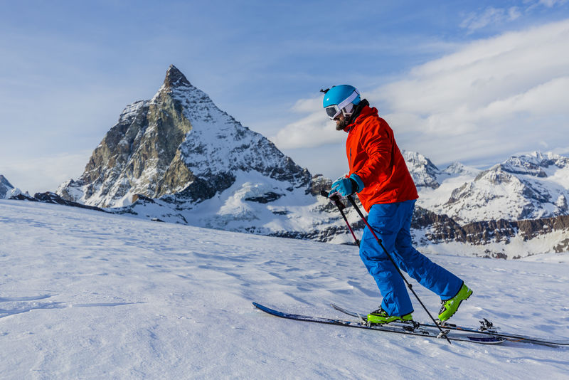 在瑞士阿尔卑斯山滑雪旅行的人到达山顶马特霍恩
